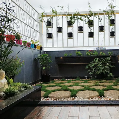 This terrace garden for the 'Opulent Abode' penthouse is a perfect urban sanctuary. I used hexagonal stone pavers with grass joints, a small water feature, and a calming Buddha statue to create a space for peace and meditation.