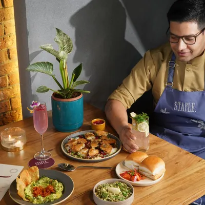 Capturing the chef's passion and the beautiful spread of modern Indian cuisine. This shot for Staple Delhi showcases the variety and artistry of their menu in a single frame.