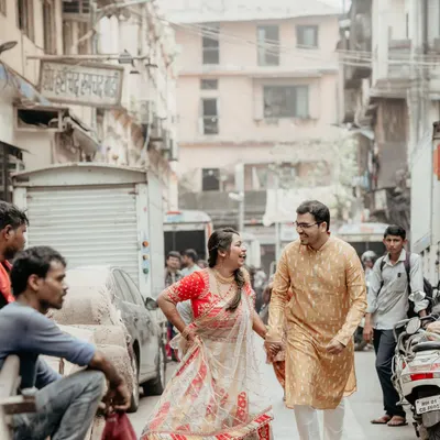 A candid moment of laughter and fun while walking through a busy Mumbai lane. We love capturing the energy of the city as a backdrop to a couple's love story.