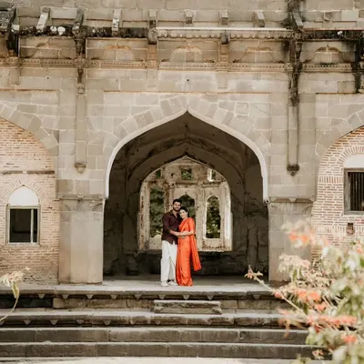 Using the grand architecture of a historic fort as a backdrop for a pre-wedding shoot. The scale of the location adds a sense of timelessness to the couple's portraits.