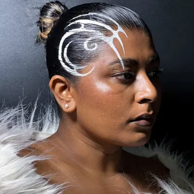 Why limit liner to the eyes? For this experimental look, I painted a graphic white design directly onto the hair for a unique, avant-garde statement.