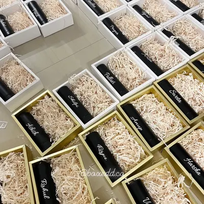 We love the challenge of bulk personalized orders. This image shows rows of gift boxes being prepared, each containing a tumbler customized with a different name for a corporate event.