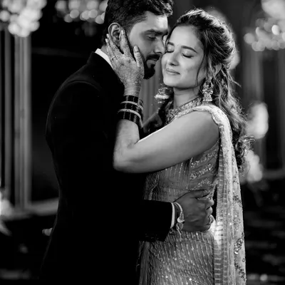 In this black and white portrait from their sangeet, all the focus is on the tender emotion between Sanket and Ruchi. The soft lighting and close embrace create a timeless, romantic feel.