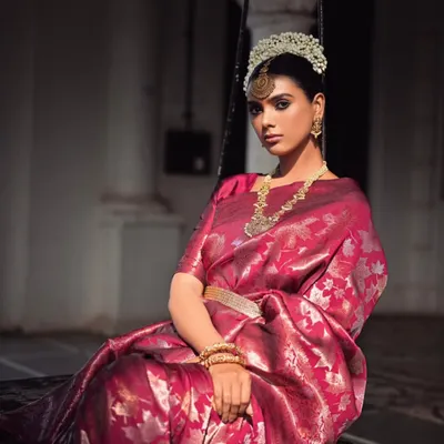 For this saree campaign, I created a look of royal elegance. The model is styled in a rich magenta Banarasi silk saree, complemented by a traditional 'gajra' headpiece and temple jewelry, seated on a swing to evoke a sense of timeless grace.