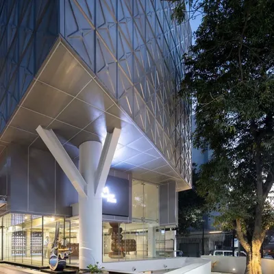 The entrance to MAP is marked by a symbolic tree-like column, grounding the modern structure and creating a welcoming transition from the street into the world of art.
