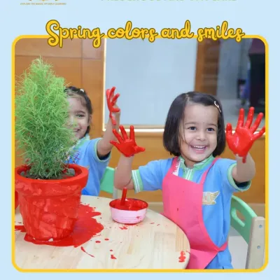 Spring colors and smiles. This joyful photo of a child with paint on her hands perfectly captures the messy, happy, and creative spirit of our art activities.