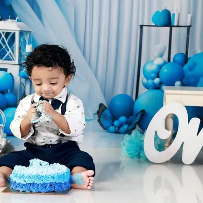 Nothing says "Happy First Birthday" like a cake smash! This little one is having the time of his life with his own cake against our custom blue balloon backdrop. I focus on capturing the messy, candid, and joyful moments of this big milestone.