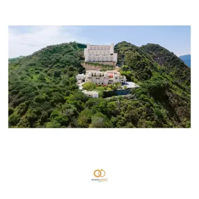 An aerial view of the majestic Alila Bishangarh, a warrior fort turned heritage hotel, standing proudly on a granite hill. This was the incredible stage for Aishwarya and Raghav's destination wedding.