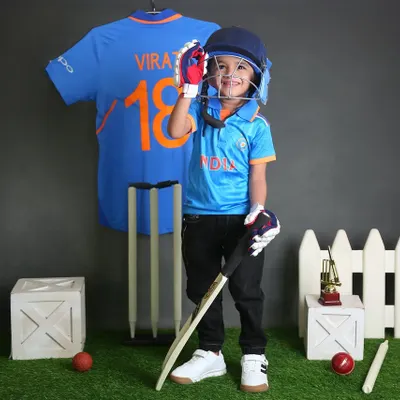 Ready to play for Team India. This little cricketer, complete with a helmet and bat, looks like a future star in our cricket-themed setup. It's a popular choice for young sports fans.