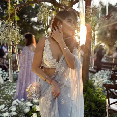 Golden hour at a day wedding. This light, ethereal saree with delicate floral embroidery is perfect for an outdoor celebration.