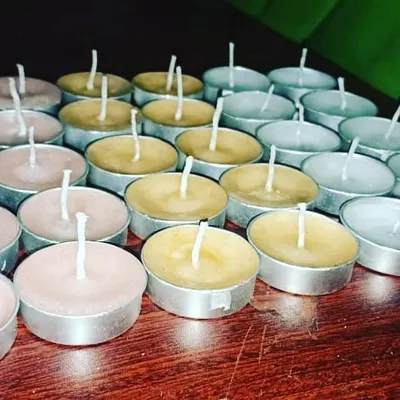 A collection of my handmade tealights in different colors, ready for packaging. You can see the quality wicks I use to ensure a consistent flame.