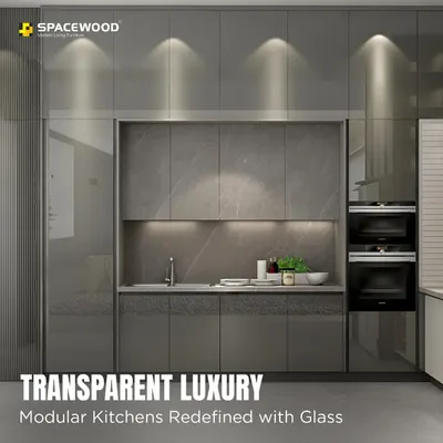 I use glass cabinetry to add a touch of transparent luxury and make a kitchen feel more open. This design features high-gloss grey cabinets with smoked glass doors and internal lighting, perfect for showcasing your finest glassware while maintaining a clean, modern look.
