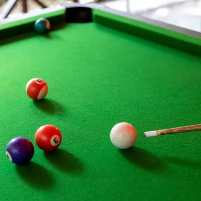 Line up the perfect shot at our pool table. It's a great way to unwind with colleagues and engage in some friendly competition.