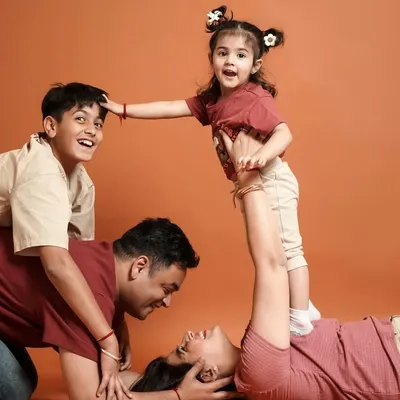 This is what pure family fun looks like. We love capturing these playful, candid moments that show the unique bond and joy within a family.