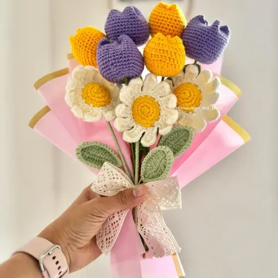 This is another angle of the custom birthday bouquet, showing the arrangement of daisies and tulips. The combination of different flower types and colors makes each handmade bouquet one of a kind.