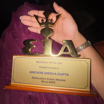 Holding my "Emcee of the Year" trophy from the Excellency Iconic Awards. This award represents years of hard work and my journey from a small town to the big city stage.