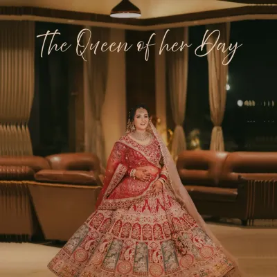 A breathtaking full-length portrait of the bride, showcasing her magnificent lehenga spread out like a queen's gown. A true statement shot.