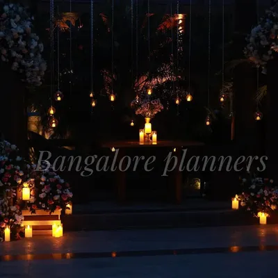 A breathtaking outdoor dinner setting designed for pure romance. I used dozens of hanging lights and candles to create a magical, intimate atmosphere around a private table for two.