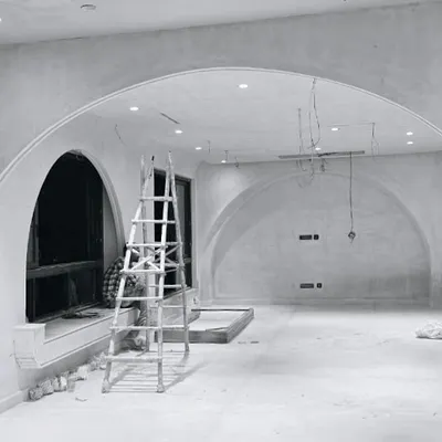 A residential space under construction, where we are introducing a series of arches to shape the room. These classical forms soften the interior and create elegant, flowing transitions between spaces.