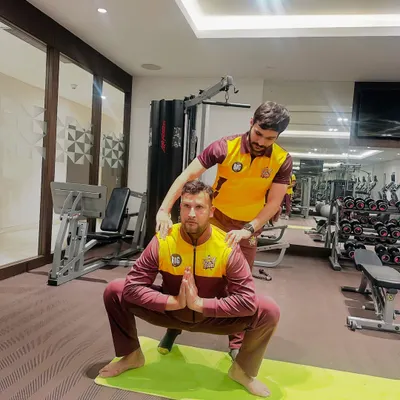 I provide hands-on adjustments to ensure athletes achieve correct posture, like in this Malasana (Garland Pose) with cricketer Ishwar Pandey. This focus on form is crucial for building foundational strength and preventing injuries.