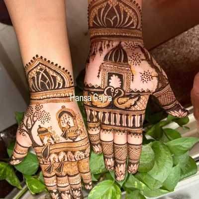 A beautiful Karwachauth design featuring a woman looking through the sieve, surrounded by swans and architectural domes. This is storytelling through henna, perfect for the special day.