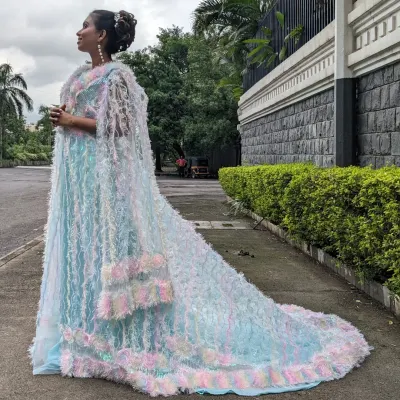 This unique unicorn jacket gown is a true statement piece. The iridescent, feathery cape is detachable, and it's available in a mother-daughter combo.