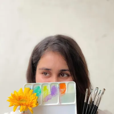 A photo of me with my art supplies, reflecting on my creative process.