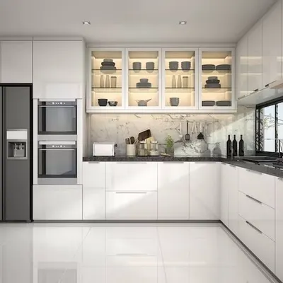 A pristine, all-white modular kitchen featuring handleless cabinets, built-in appliances, and illuminated glass-front upper cabinets for a sophisticated display.