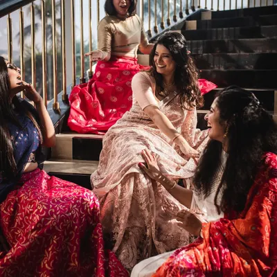 Capturing the fun and gossip with the bride tribe. These candid moments on the stairs show the genuine friendship and excitement of the day.