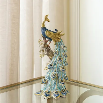 This majestic peacock showpiece is a customer favorite. The intricate detailing on its cascading tail feathers, finished in beautiful shades of blue and gold, makes it a stunning symbol of grace and beauty.