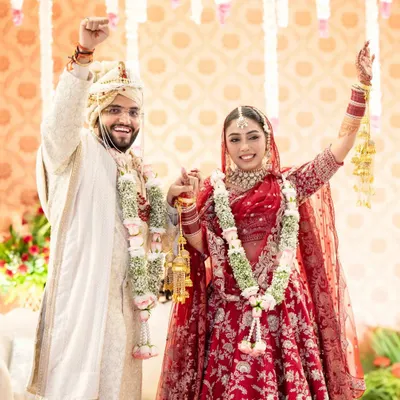 The moment of pure triumph and joy after the varmala ceremony. I love capturing the energy as the couple celebrates becoming husband and wife.