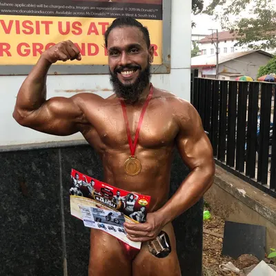 Victory on stage. Holding a medal after a bodybuilding competition is a reward for months of relentless training and dieting. I use my competitive experience to guide athletes through their own prep.
