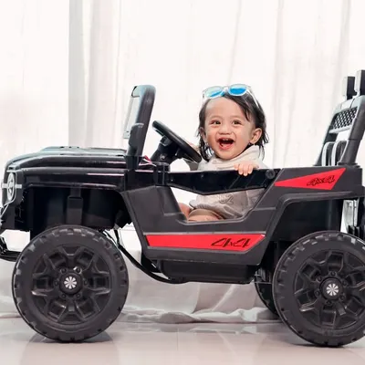 License to be cute. This little driver is having a blast in our toy jeep, a prop that always brings out the biggest smiles.