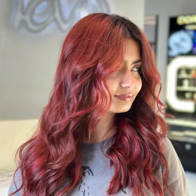 Red vibes only. This fiery red hair color is bold, vibrant, and full of passion. A true statement look.