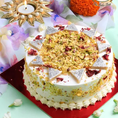 Our Kaju Katli Cake is a festive masterpiece, combining the beloved flavor of the traditional sweet with a soft, creamy cake. It's decorated with real Kaju Katli pieces and chopped pistachios for an authentic touch.