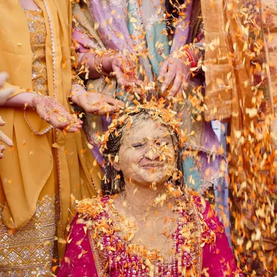 A moment of pure bliss as the bride is showered with marigold petals during her haldi. I focus on capturing these beautiful, candid rituals that are full of emotion.