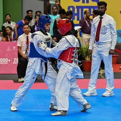Refereeing a Kyorugi (sparring) match at the 37th National Games in Goa. My position on the mat gives me firsthand knowledge of high-level competition dynamics.