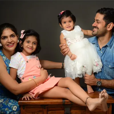 A happy family of four during their studio session. I aim to capture both posed and candid moments that show the love and connection between parents and children.