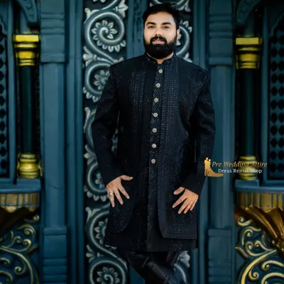 This is a closer look at my black textured sherwani. The intricate, self-color pattern and premium buttons give it a sophisticated and modern edge, perfect for pairing with a vibrant lehenga.