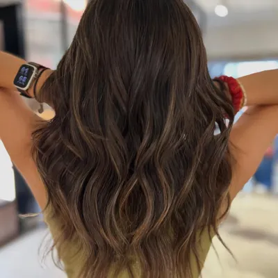 This brunette balayage adds incredible movement and the illusion of volume. I used a two-tone beige blend to create soft, natural-looking dimension that complements her base color perfectly.