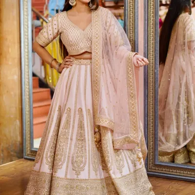 Pastel perfection for a daytime celebration. This light pink lehenga with delicate gold embroidery is soft, romantic, and gives you an ethereal glow.