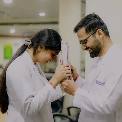 Back to the classroom where their story began. This playful shot with a medical instrument is a perfect example of a themed shoot that is both fun and deeply personal to the couple's journey as doctors.