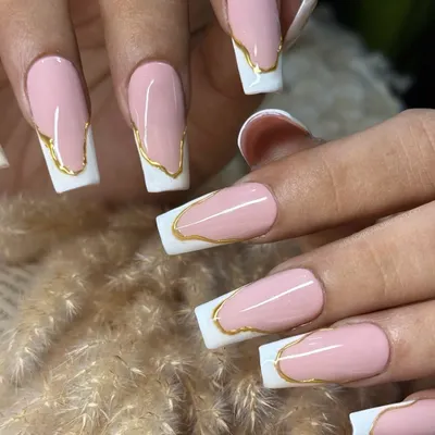 This is a futuristic take on the French manicure, featuring long, square-shaped nails with a crisp white tip. I added a flowing, abstract gold chrome line to separate the pink base from the white tip for a bold and edgy look.