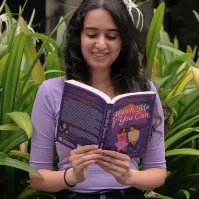 Celebrating the UK release day for my debut novel, *Match Me If You Can*. This photo was taken in a beautiful garden, and I'm so excited for UK readers to meet Jia and Jaiman.