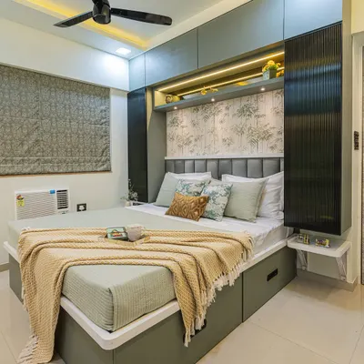 This bedroom is designed to be a calm retreat. I used a soothing green and beige color palette, a nature-themed wallpaper, and overhead storage to maximize space while keeping the room feeling uncluttered and serene.