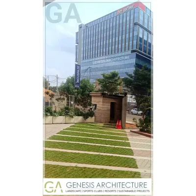 The landscape design for this corporate office in Bangalore integrates green spaces directly into the commercial environment. The use of grass pavers and native plants helps manage stormwater and creates a more pleasant, natural setting for employees.