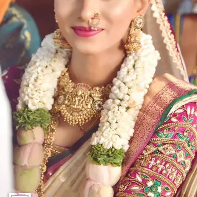 A beautiful, happy bride on her wedding day. I created this smooth, natural makeup look to enhance her features without feeling heavy, perfectly matching her traditional saree and temple jewellery.