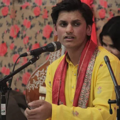 A young student performing with complete focus during the 'Raghunathanjali' Swarveni Baithak. Providing a stage for students to present their art is a cornerstone of our academy.