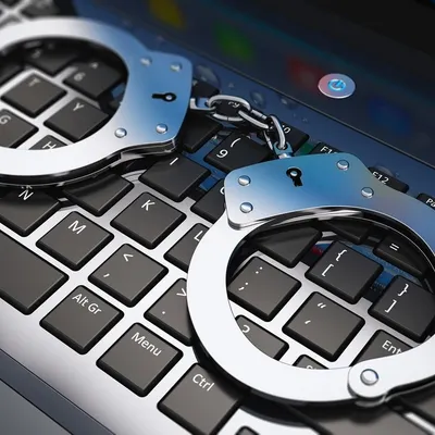 Handcuffs on a keyboard symbolize the serious nature of cybercrime. If you are a victim of online financial fraud, identity theft, or harassment, I can help you take legal action against the perpetrators under India's cyber laws.
