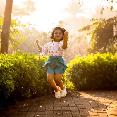 A birthday jump for joy! I love encouraging kids to move and play during our outdoor sessions. This spontaneous moment of excitement perfectly captures the energy of a happy three-year-old.